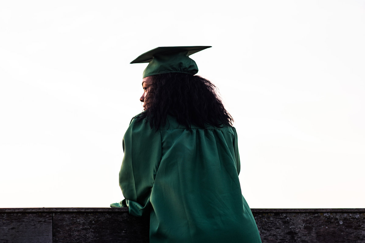Woman in green graduate robes